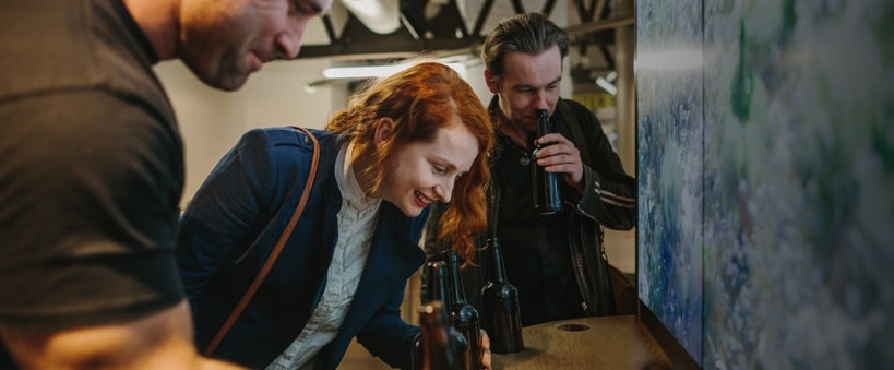 Redheaded woman looking into bottle